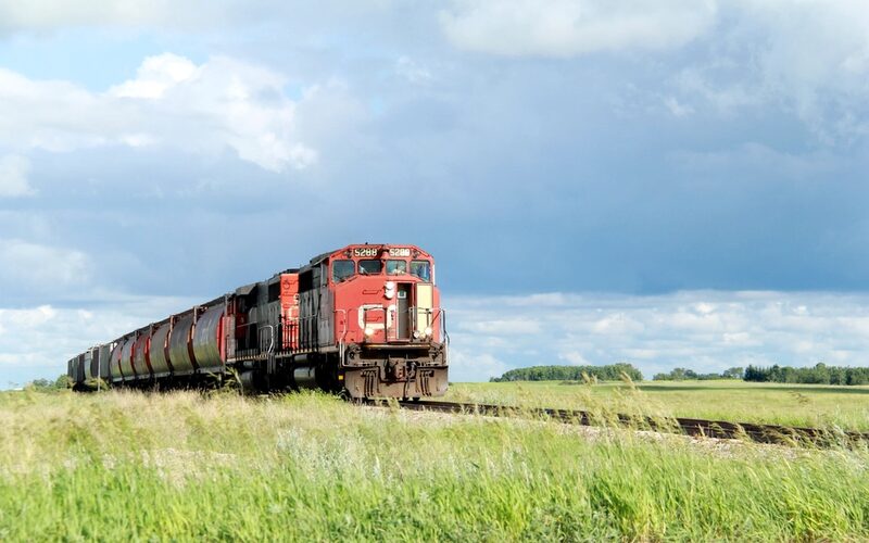 Freight train hauling cargo through open country