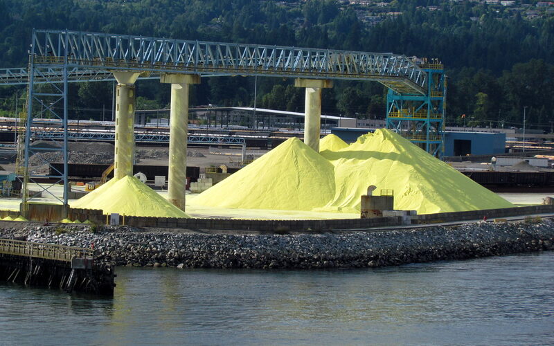 Bright yellow sulphur piles awaiting export at a port terminal